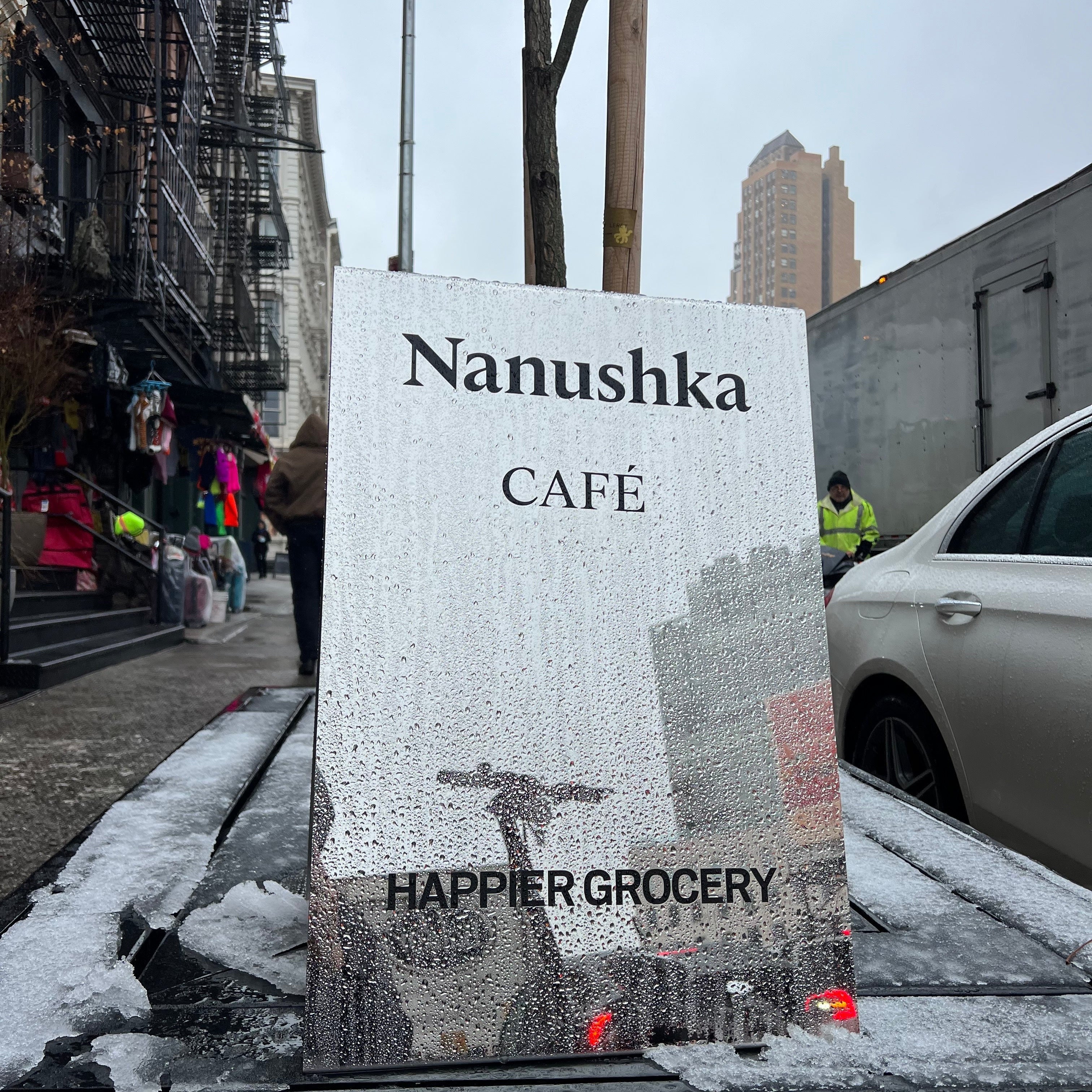 Nanushka Cafe and Happier Grocery Mirror Sidewalk Sign