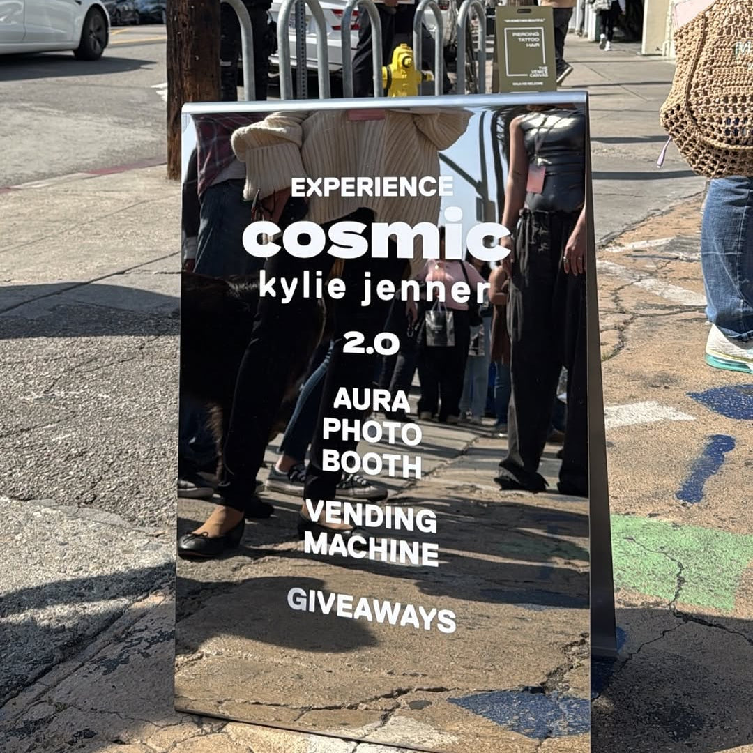 Mirrored A-frame sign advertising the Cosmic Kylie Jenner event.