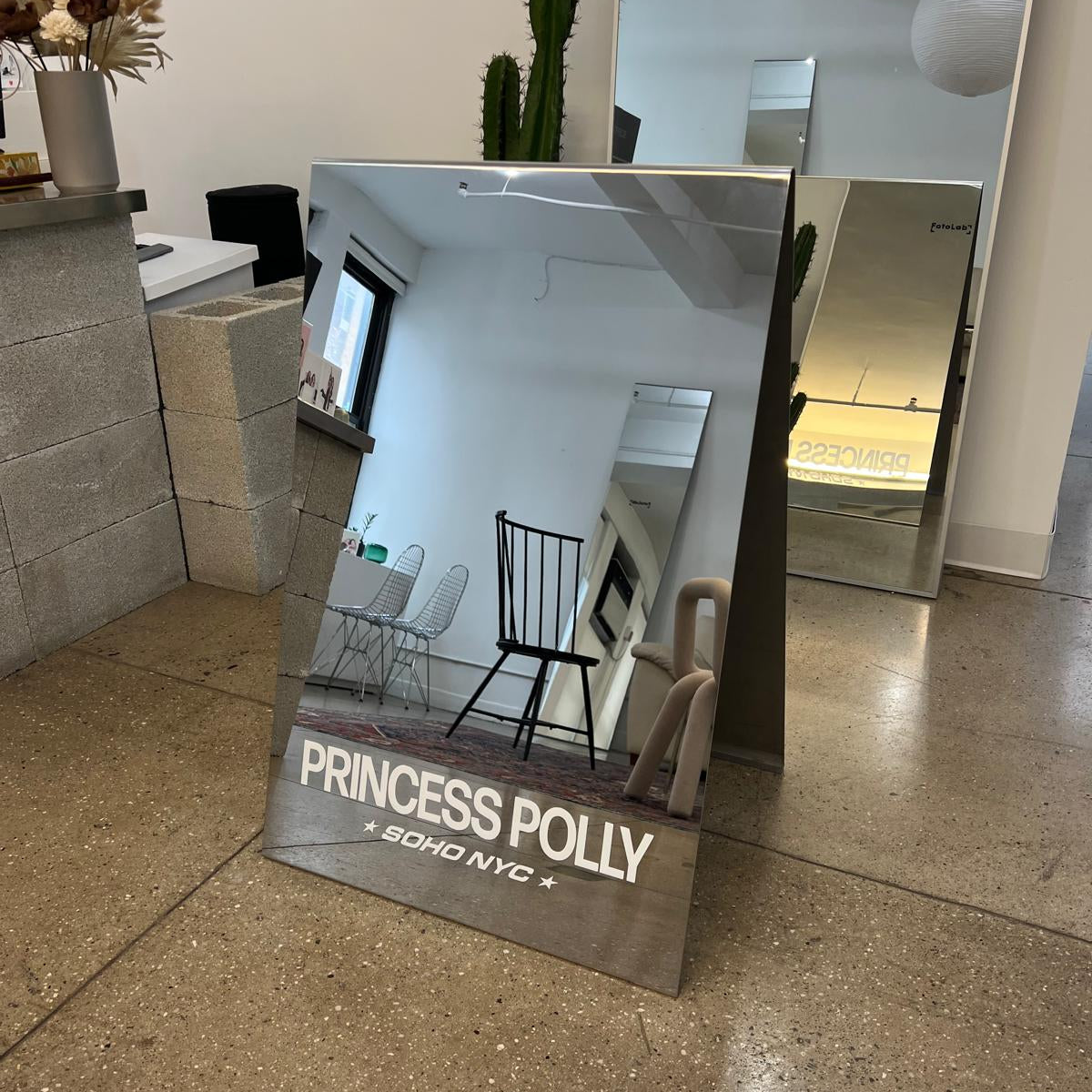 Mirrored Princess Polly A-frame sign displayed indoors.