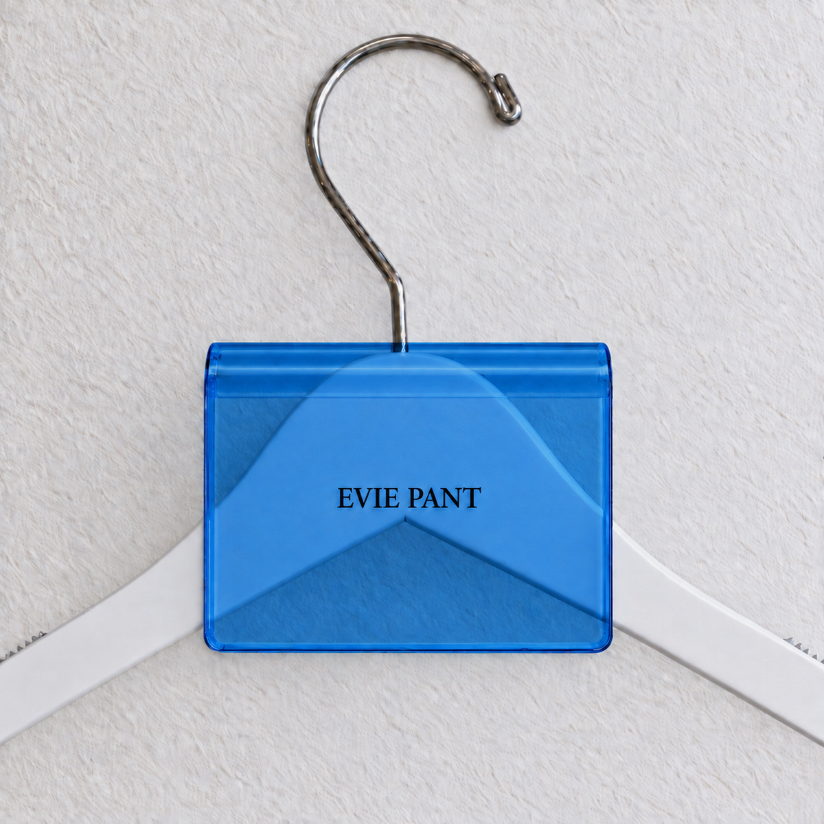 Dark Blue acrylic hanger sign clip with soft edge reflections, resting on a white wooden hanger, with example EVIE PANT print