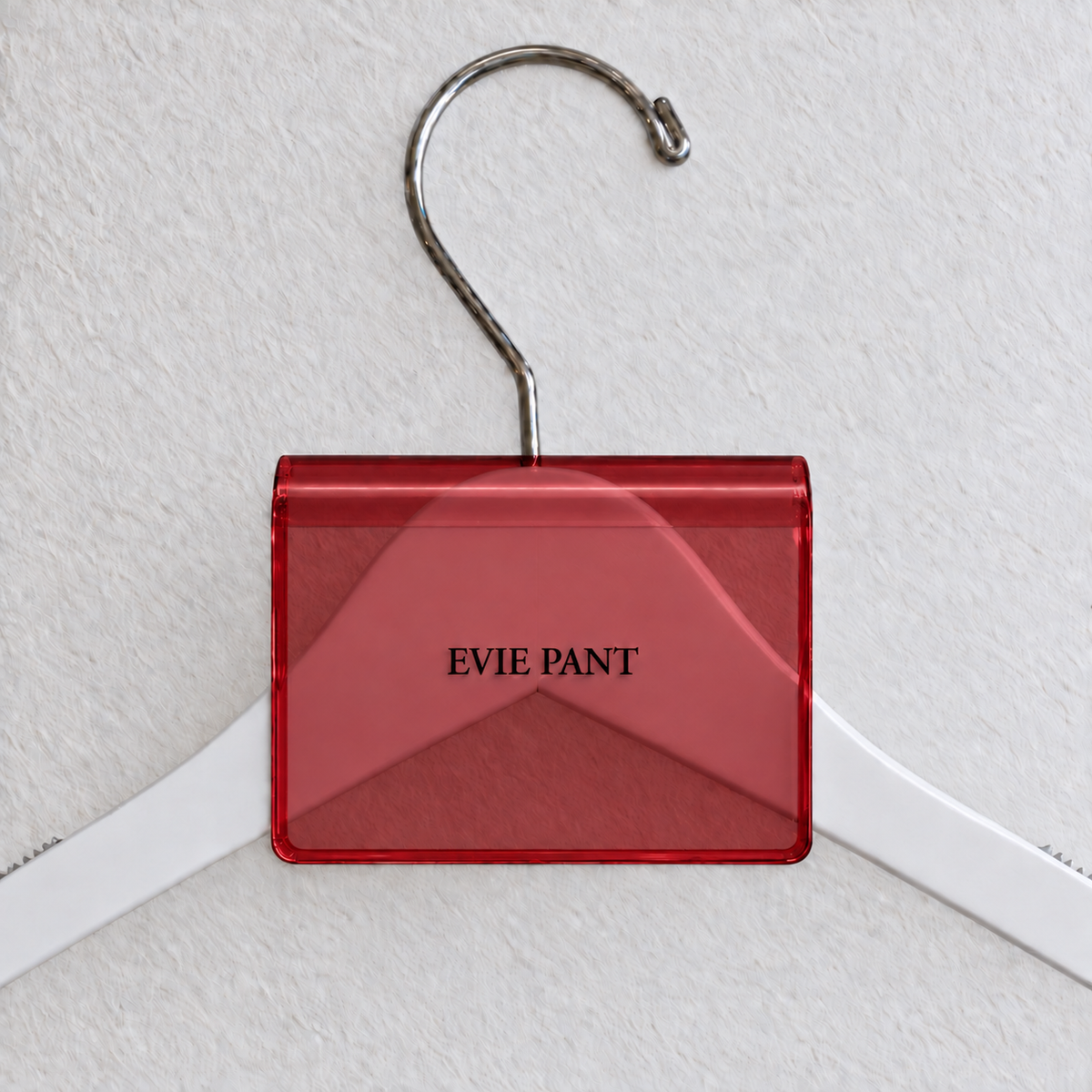 Red transparent acrylic hanger sign clip with soft edge reflections, resting on a white wooden hanger, with example EVIE PANT print
