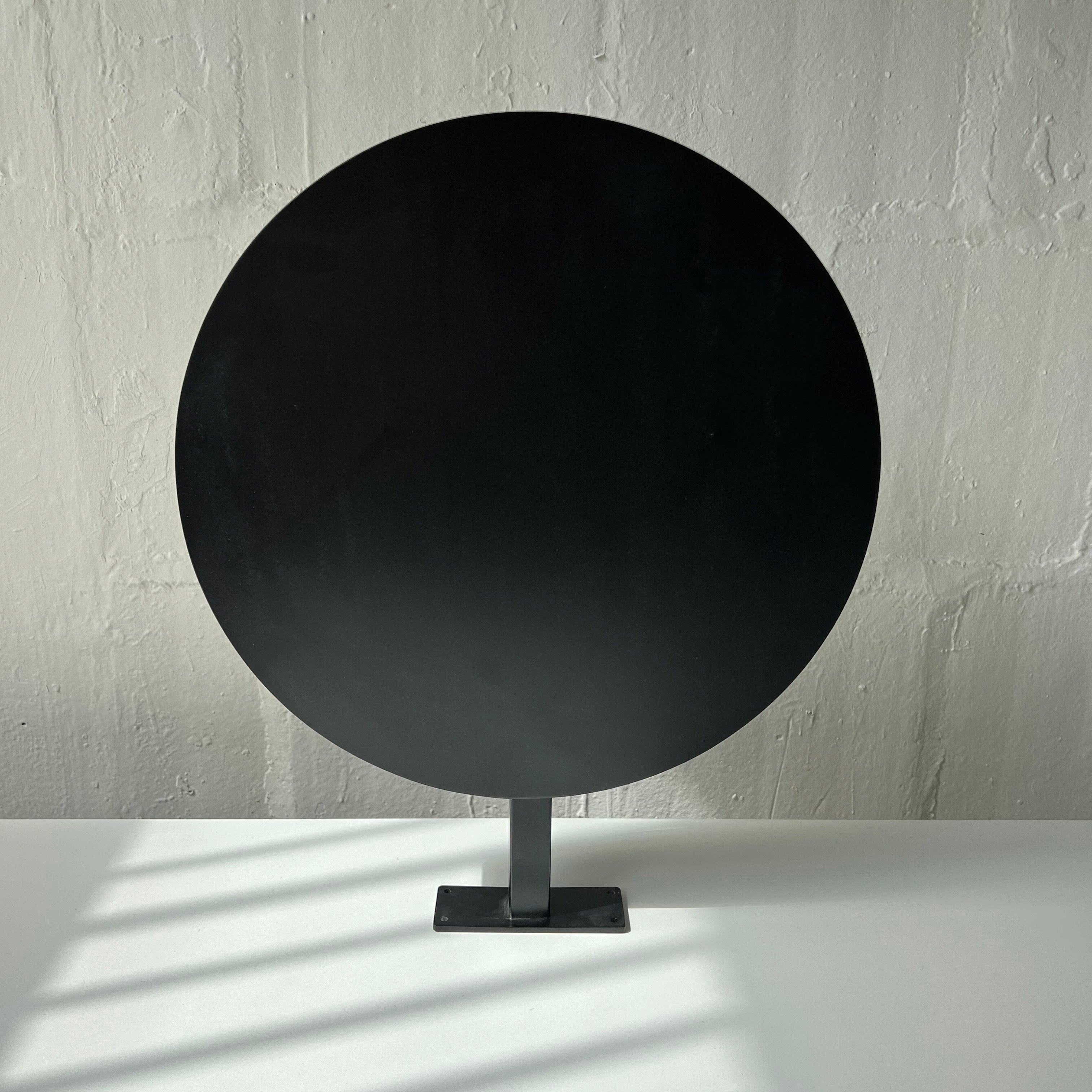 Black Circular Round Wall Sign Close Up