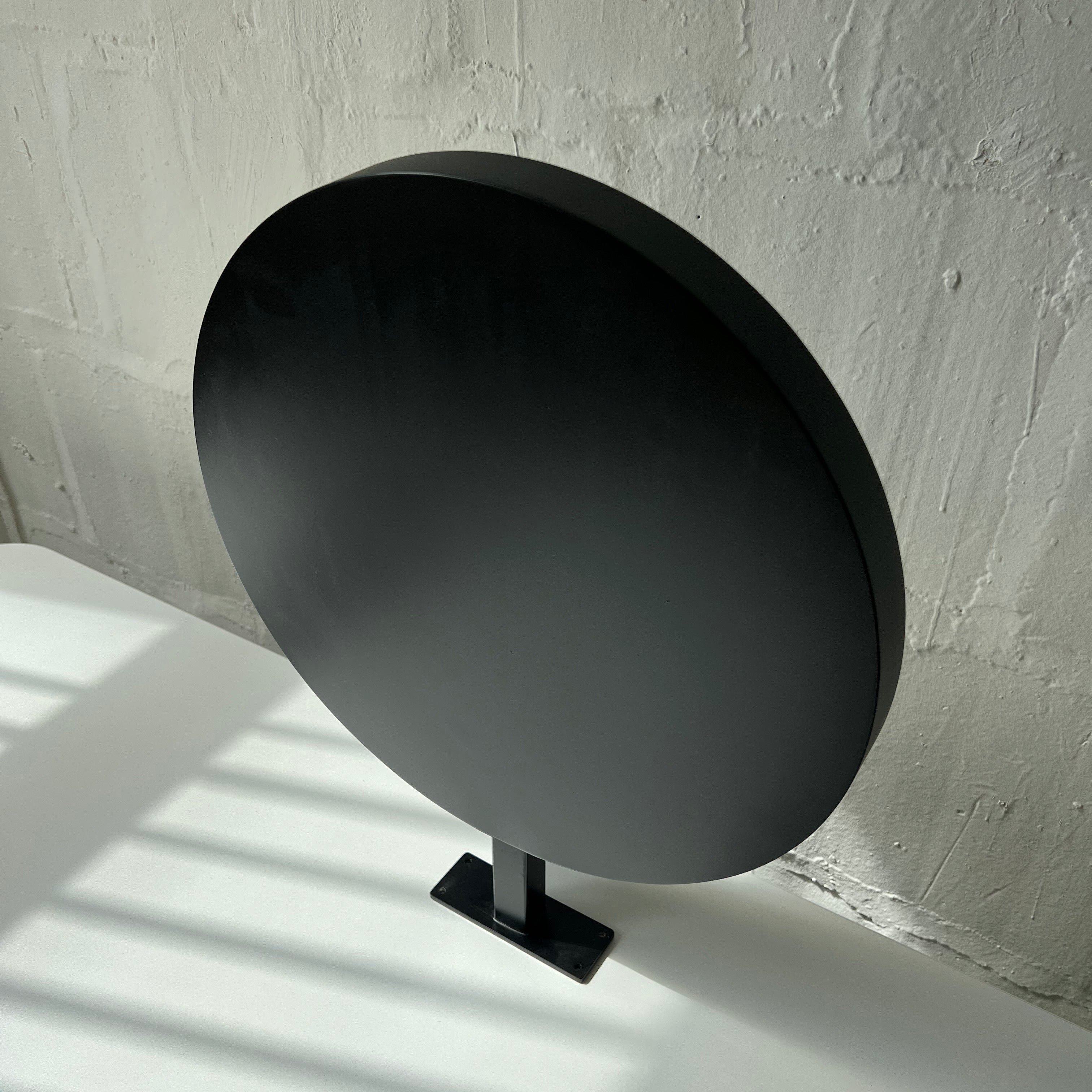 Black Circular Round Wall Sign Close Up