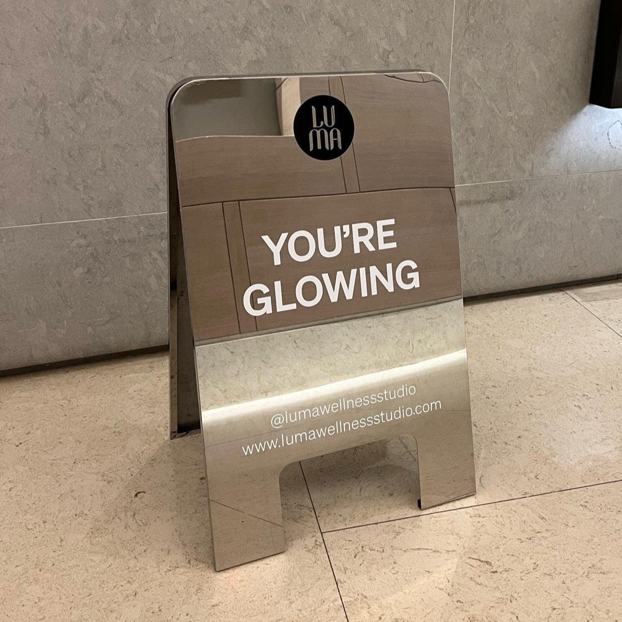 Mirrored Stainless Steel Rounded Sandwich Board LUMA Wellness Background