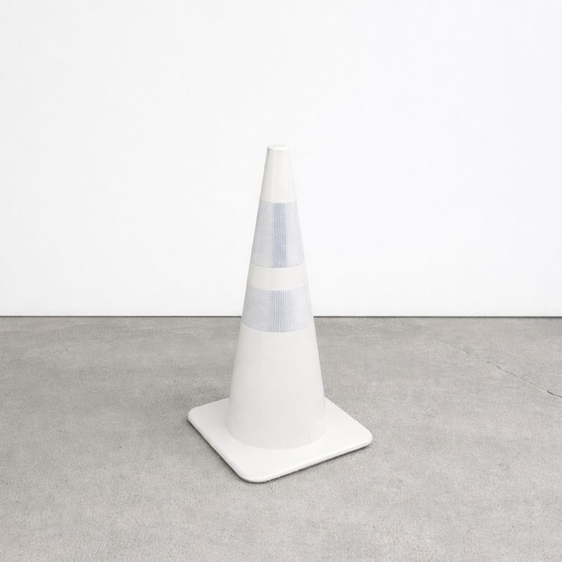 White traffic cone with 'Hey' written on it against a metallic background