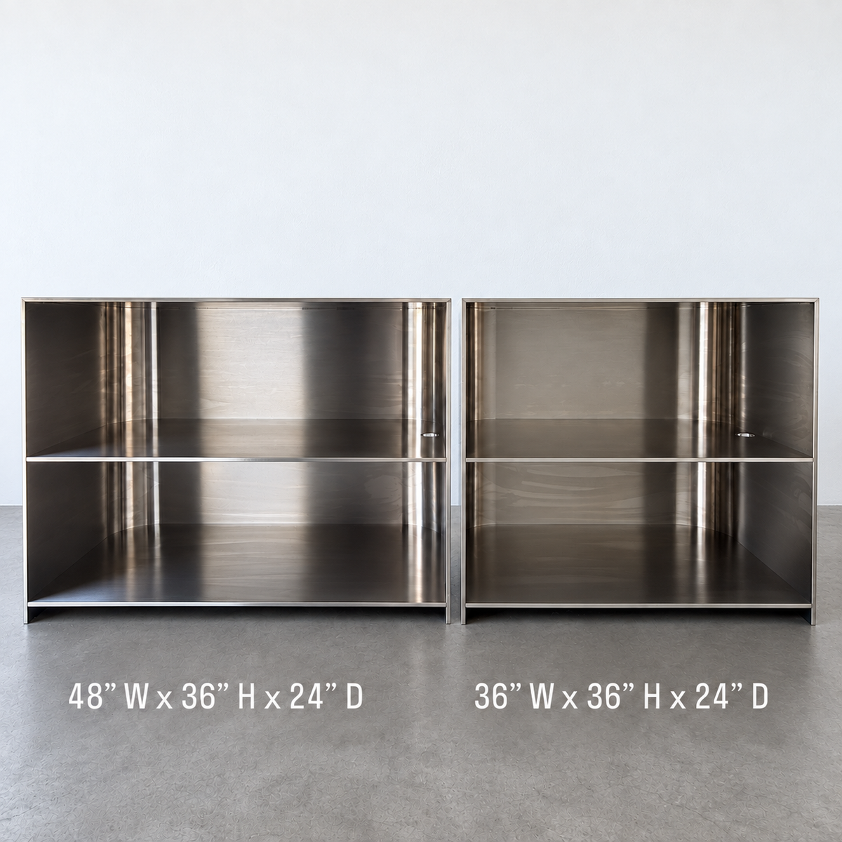 Rear comparison of 48-inch-wide and 36-inch-wide stainless steel desks showing open storage shelves.