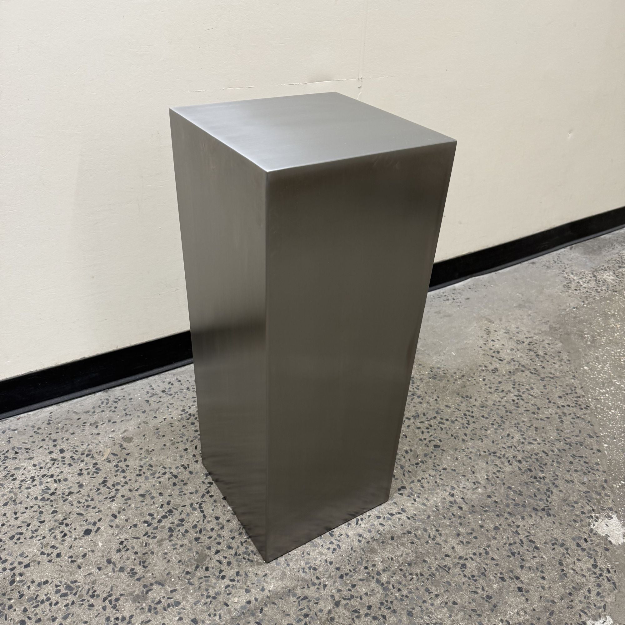 Custom stainless steel pedestals built to display mirrors, signage, and décor. Brushed finish, clean lines, made to order.