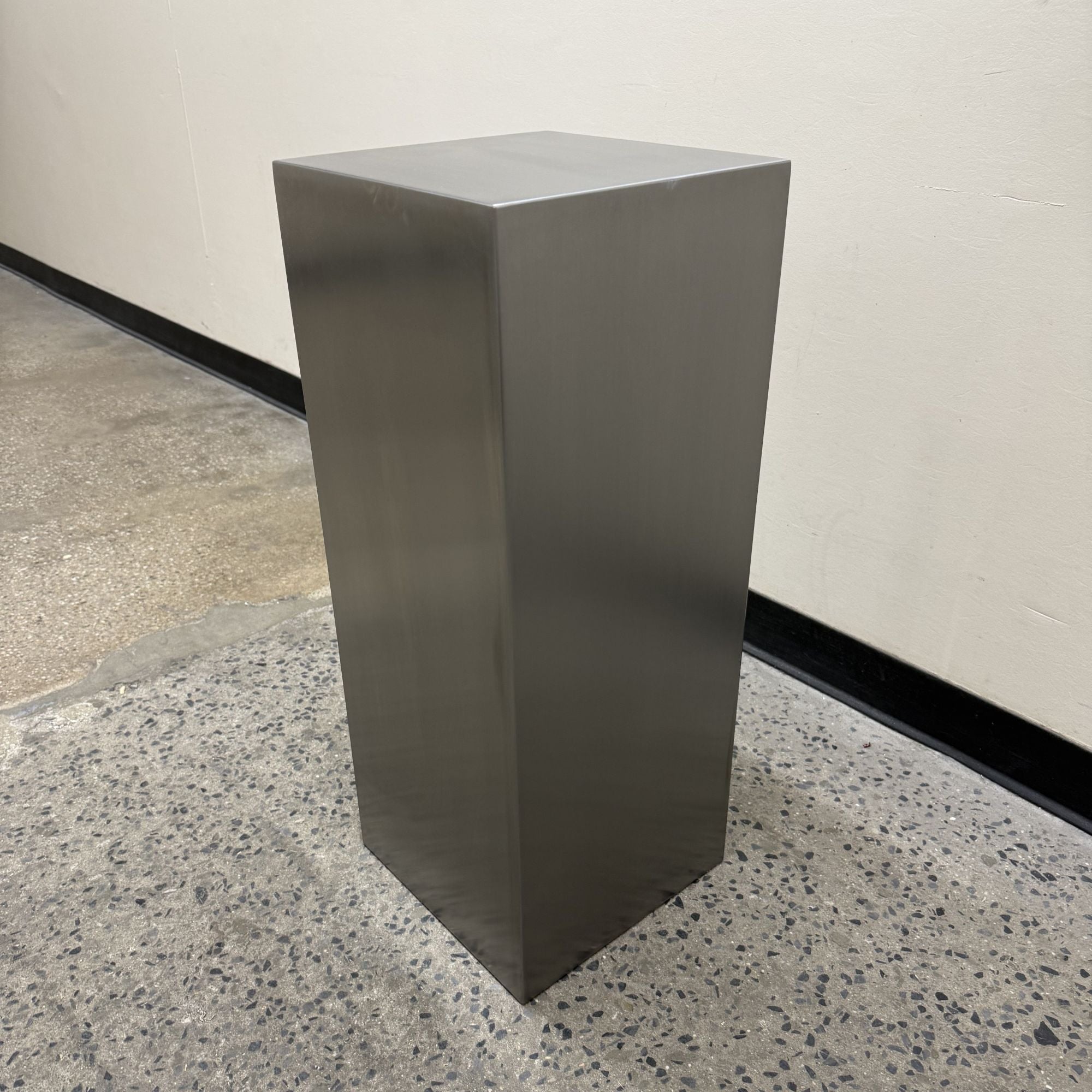 Custom stainless steel pedestals built to display mirrors, signage, and décor. Brushed finish, clean lines, made to order.