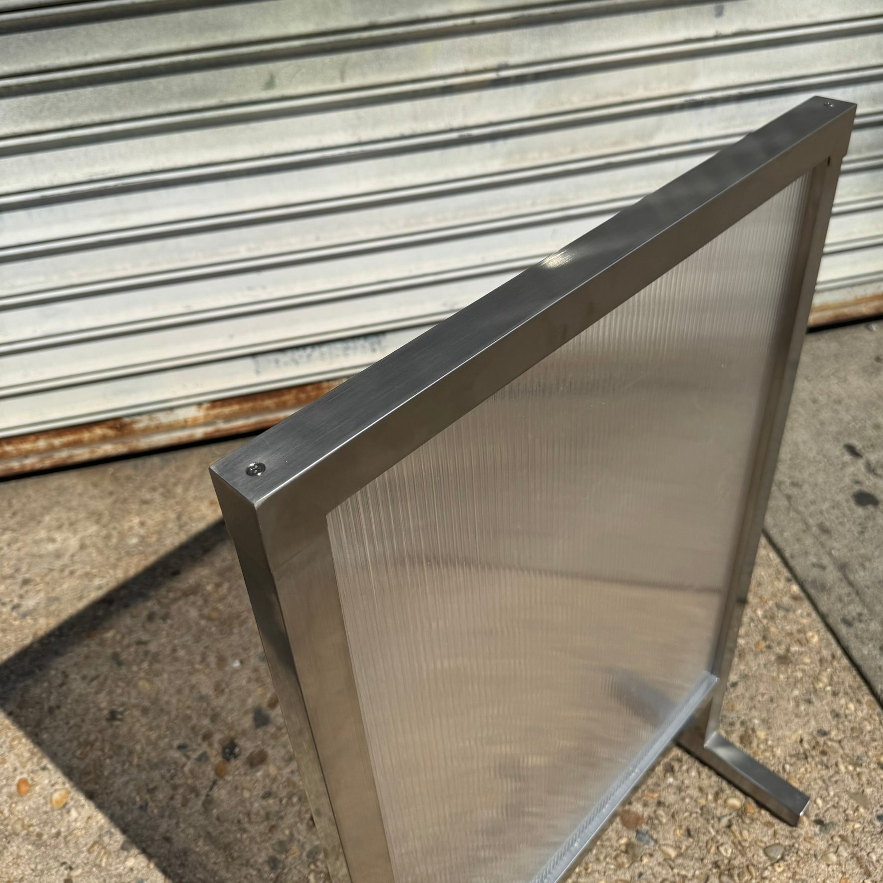 Transparent_Brushed_Stainless_Steel_Standing_Sign_Top_Detail_View