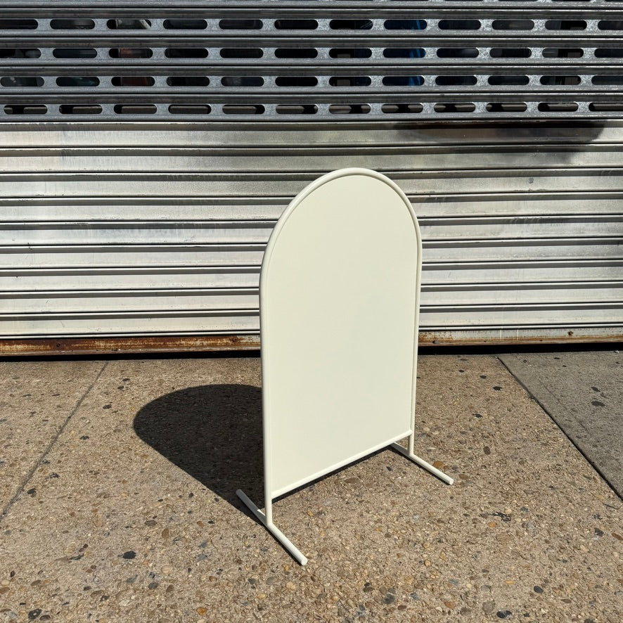 Right angled view of a blank cream arched standing sign.
