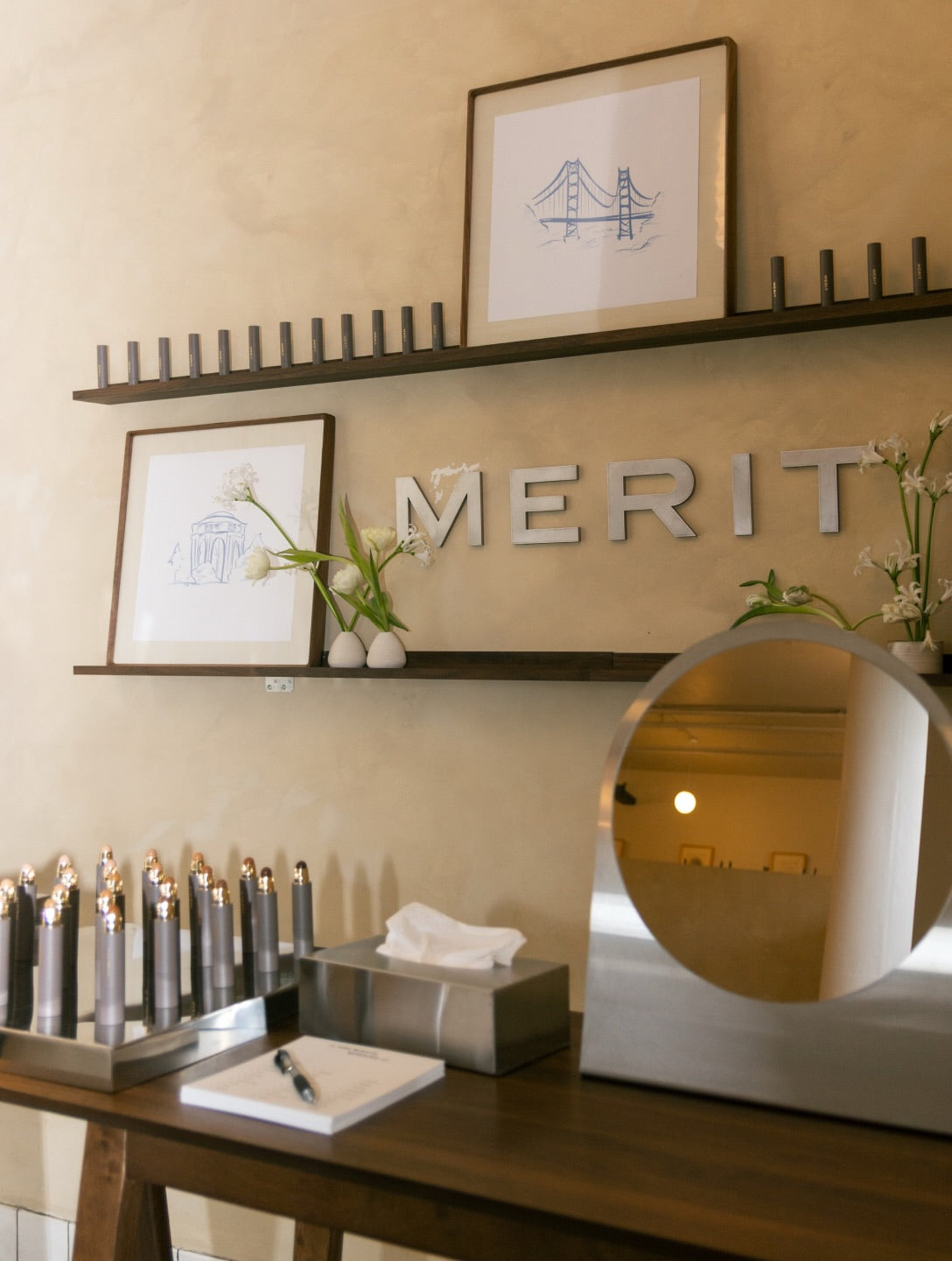 Metal Merit wall lettering between shelves above a counter.