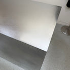 Close-up of a brushed stainless steel table surface