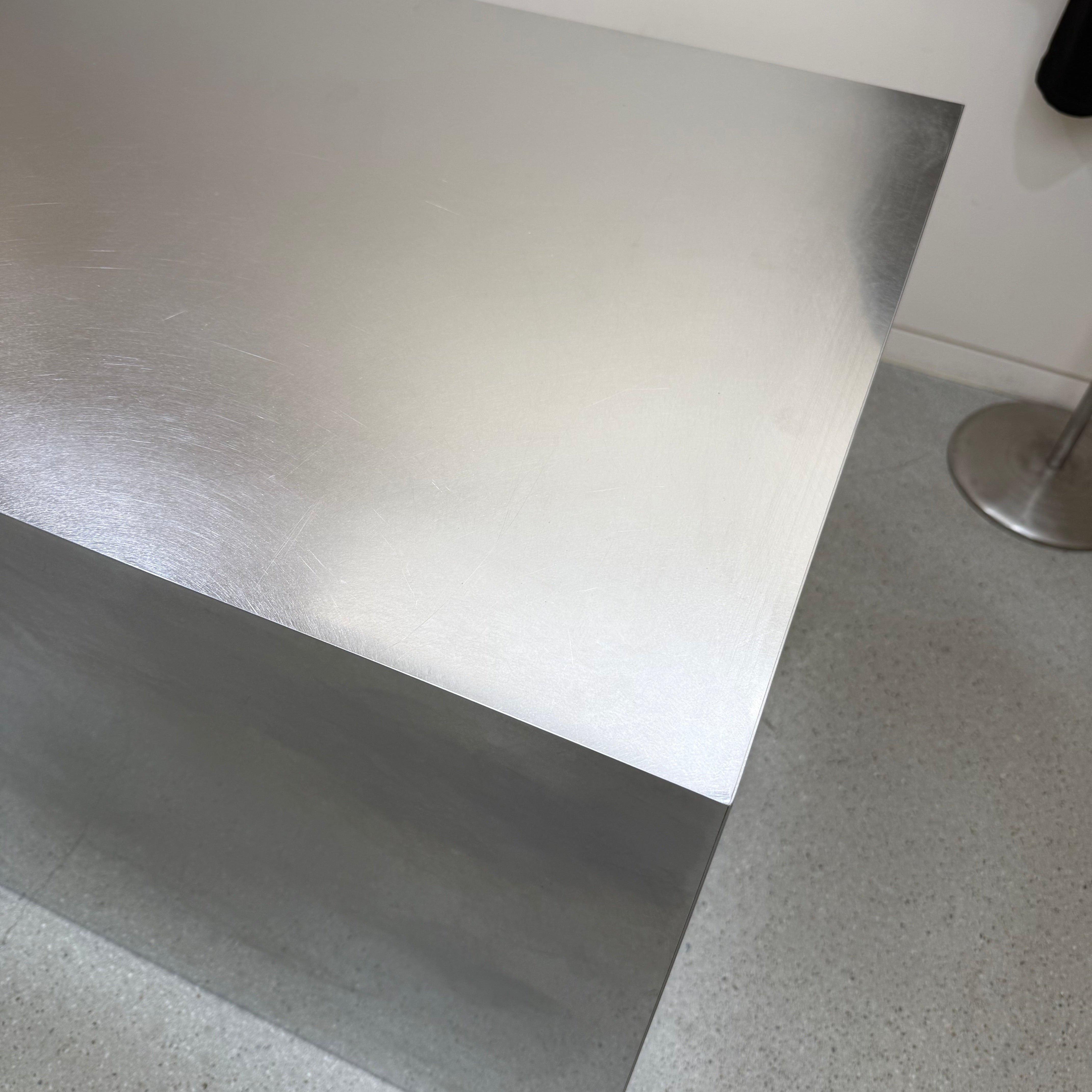 Close-up of a brushed stainless steel table surface