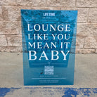 Blue transparent acrylic A-frame sign with Life Time Lounge Like You Mean It Baby lettering.